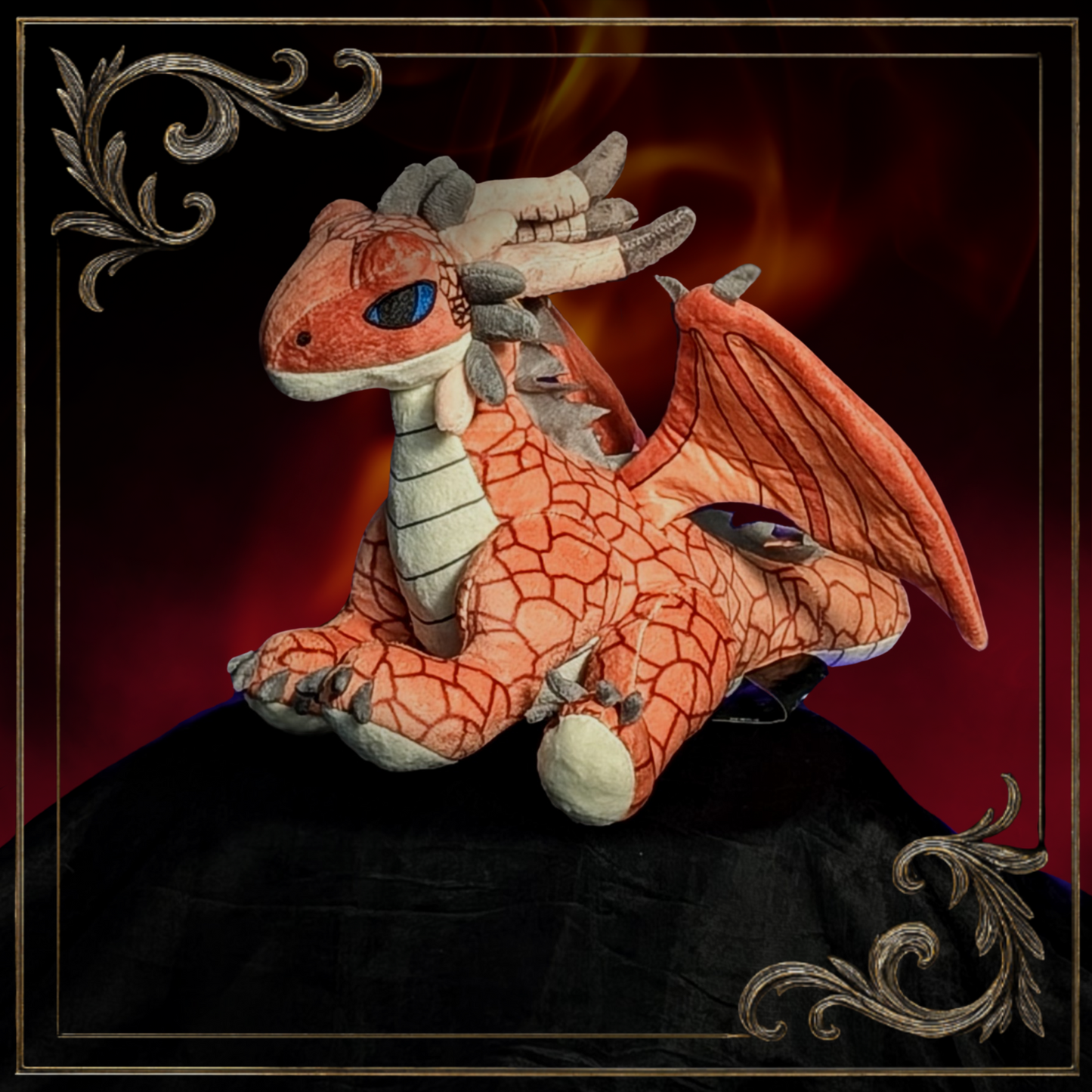 Plush dragon toy with orange and red coloring on a dark background